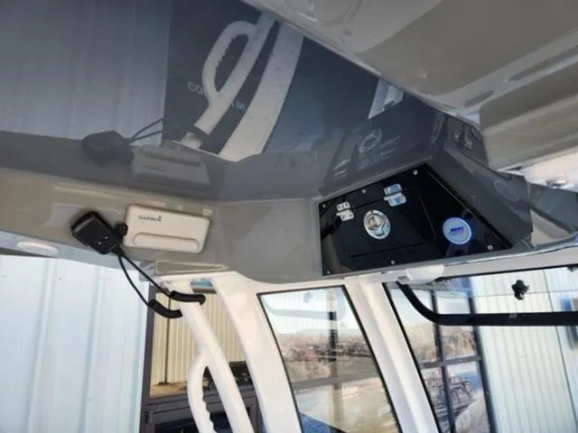 Slide: The Image of 2025 Sportsman MASTERS 247OE boat interior with electronic controls and navigation equipment. - 13