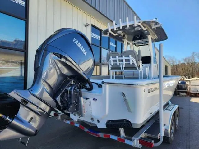 Slide: The Image of 2025 Sportsman MASTERS 247OE boat with Yamaha engine on trailer, parked outside a building. - 5