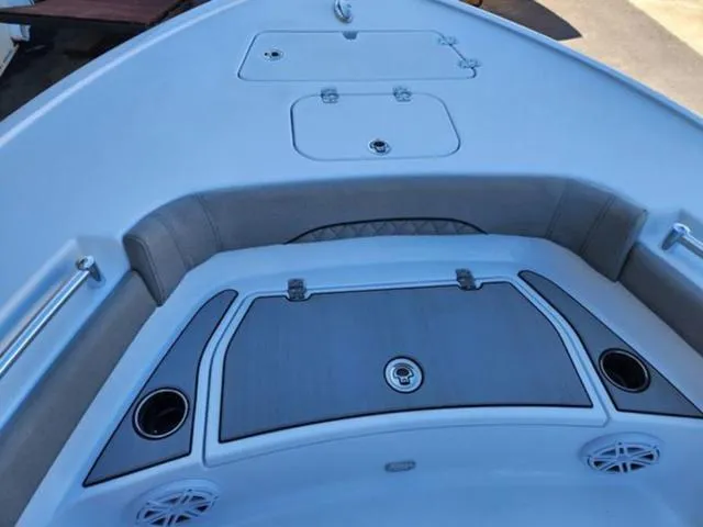 Slide: The Image of 2025 Sportsman MASTERS 247OE boat deck with storage compartments and cup holders. - 8