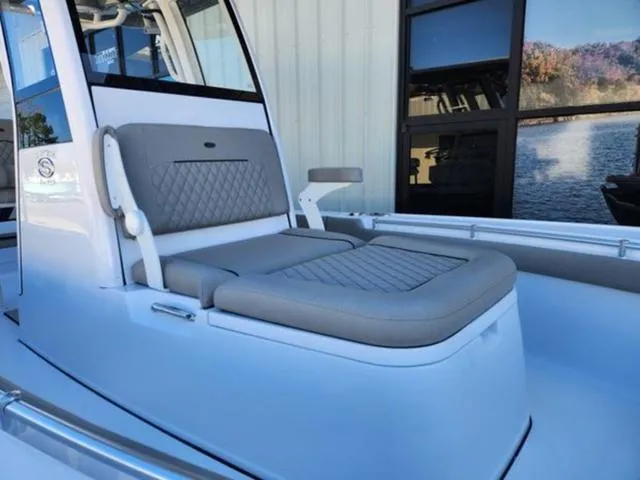 Slide: The Image of 2025 Sportsman MASTERS 247OE boat with cushioned seating and sleek design. - 9