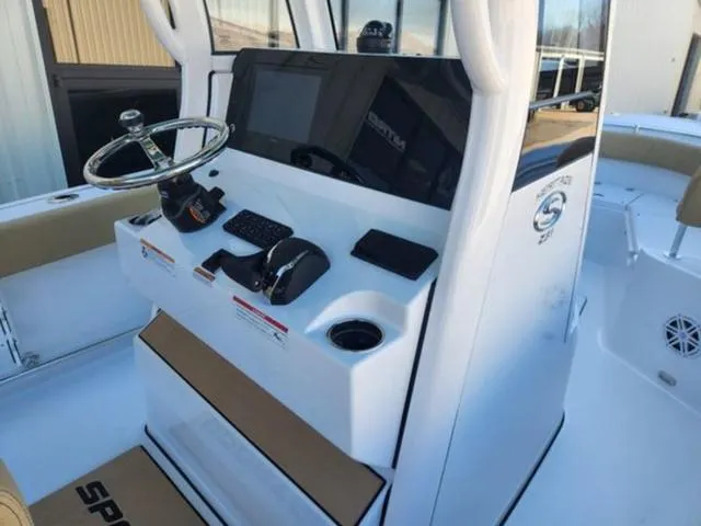 Slide: The Image of 2025 Sportsman Heritage 231 boat console with steering wheel and controls. - 10