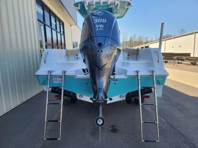 Slide: The Image of 2025 Sportsman Heritage 231 boat with Yamaha 300 V6 engine, docked outdoors. - 11