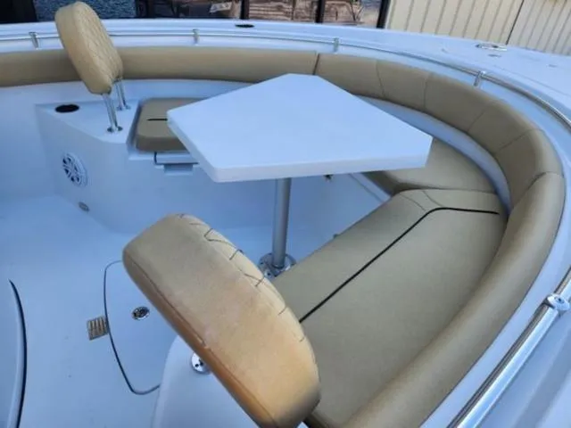 Slide: The Image of 2025 Sportsman Heritage 231 boat interior with cushioned seating and table. - 13