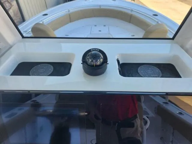 Slide: The Image of 2025 Sportsman Heritage 231 boat console with compass and cup holders. - 16