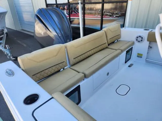 Slide: The Image of 2025 Sportsman Heritage 231 boat interior with beige seating and Yamaha engine. - 5