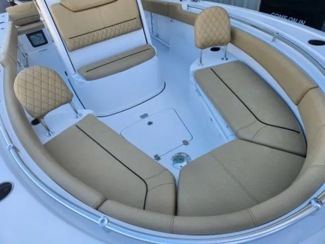 Slide: The Image of 2025 Sportsman Heritage 231 boat interior with tan cushioned seating and modern design. - 6