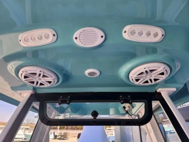 Slide: The Image of 2025 Sportsman Heritage 231 boat interior with speakers and lights on the ceiling. - 8