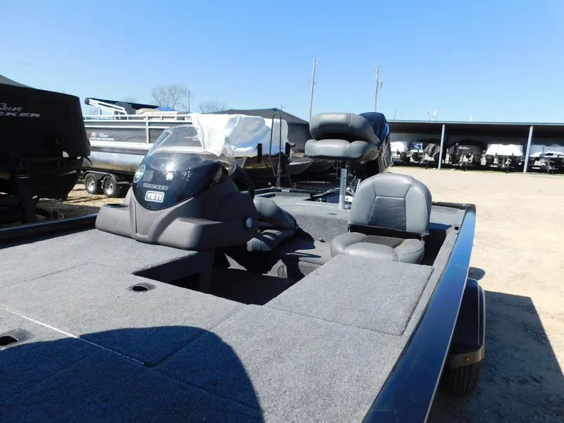 Slide: The Image of 2023 Bass Tracker 170 boat with seating and console, displayed outdoors under clear blue sky. - 3