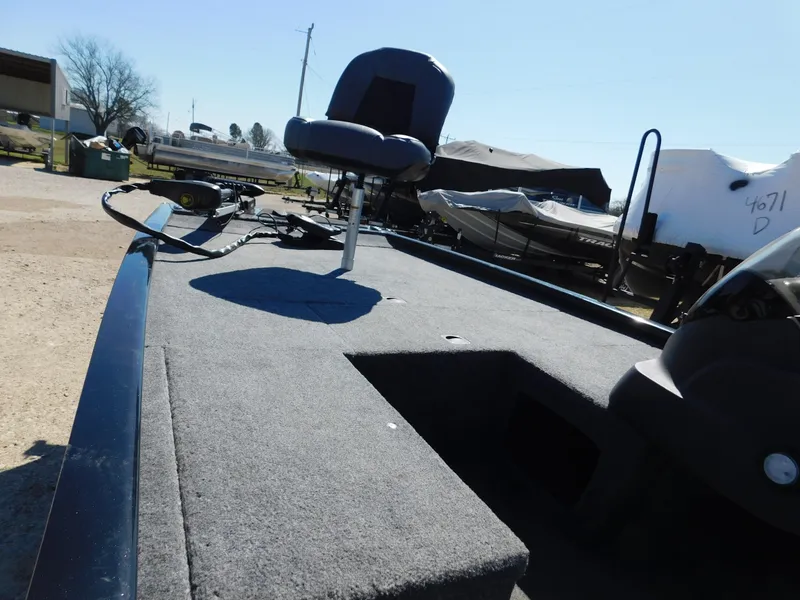 Slide: The Image of 2023 Bass Tracker 170 boat with seating and carpeted deck in outdoor setting. - 4