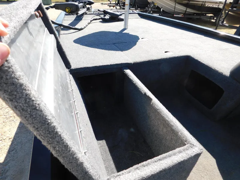 Slide: The Image of 2023 Bass Tracker 170 boat storage compartment open, showcasing interior space. - 5