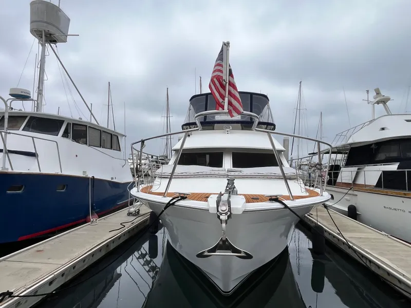 Slide: The Image of Ocean Alexander Sundeck 460 yacht, 1999 model, docked at marina with American flag. - 1