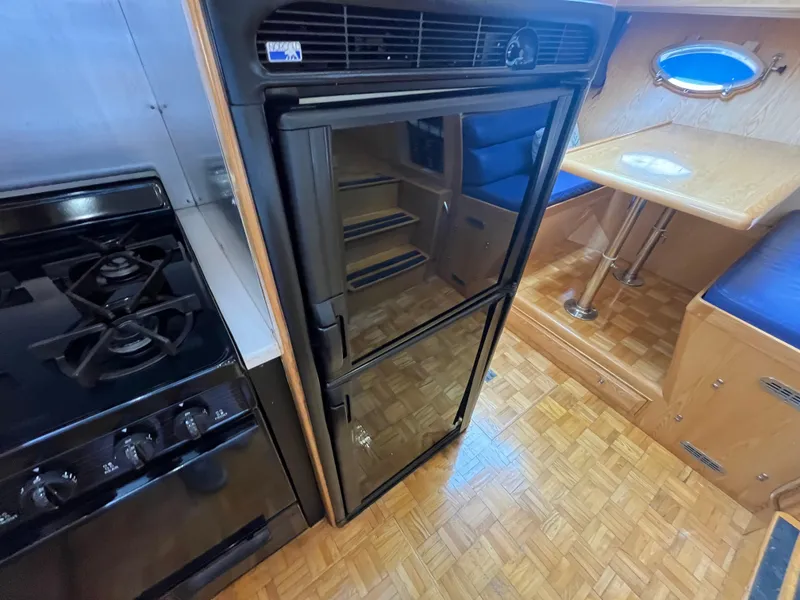 Slide: The Image of Interior of 1999 Ocean Alexander Sundeck 460, featuring kitchen and dining area. - 27