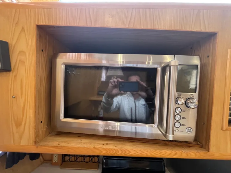 Slide: The Image of Built-in microwave in Ocean Alexander Sundeck 460 yacht, 1999 model, wooden cabinetry. - 30