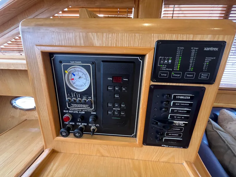 Slide: The Image of Control panel of a 1999 Ocean Alexander Sundeck 460 yacht, featuring various switches and gauges. - 31