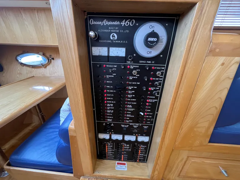 Slide: The Image of Electrical panel of 1999 Ocean Alexander Sundeck 460 yacht, featuring control switches and indicators. - 32