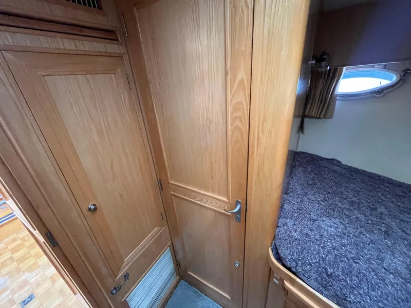 Slide: The Image of 1999 Ocean Alexander Sundeck 460 interior with wooden cabinetry and cozy sleeping area. - 35
