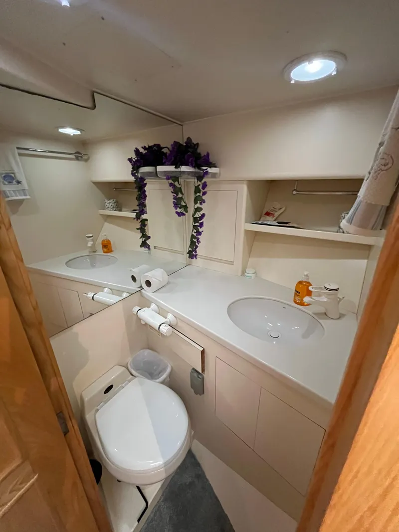 Slide: The Image of 1999 Ocean Alexander Sundeck 460 bathroom with dual sinks and modern amenities. - 36