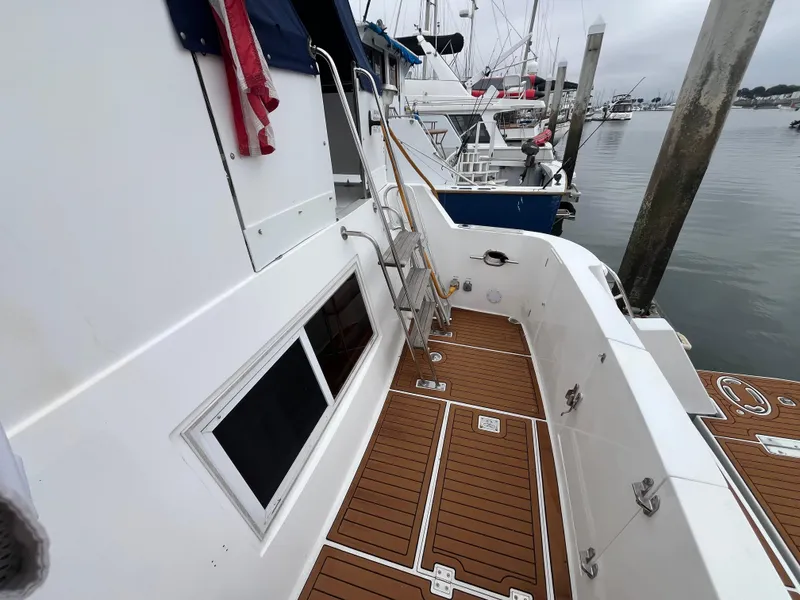 Slide: The Image of 1999 Ocean Alexander Sundeck 460 yacht with teak deck, docked at marina. - 5