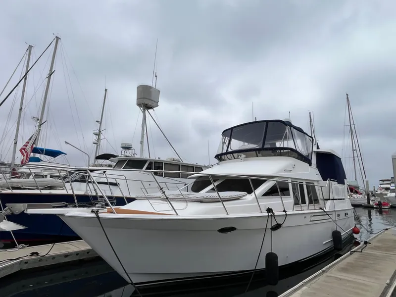 The Image of Ocean Alexander Sundeck 460 yacht, 1999 model, docked at marina under cloudy sky. - 0