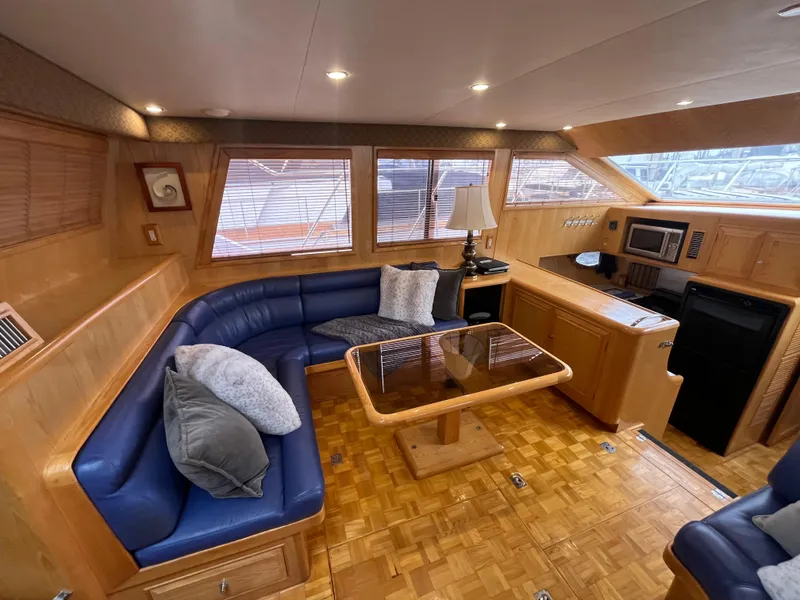 Slide: The Image of Luxurious interior of 1999 Ocean Alexander Sundeck 460 yacht with blue seating and wooden accents. - 18