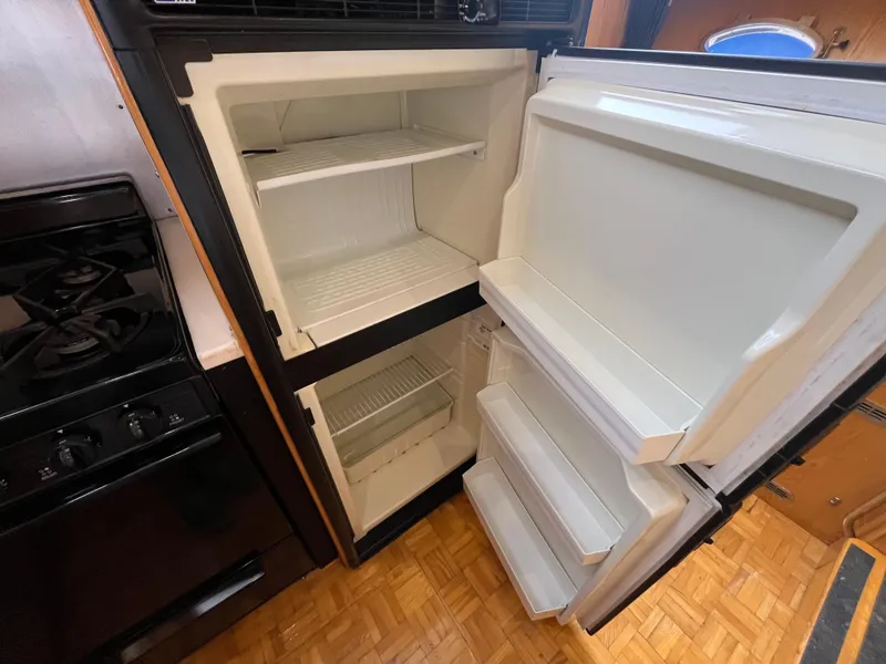 Slide: The Image of Open refrigerator and stove inside 1999 Ocean Alexander Sundeck 460 yacht kitchen. - 28