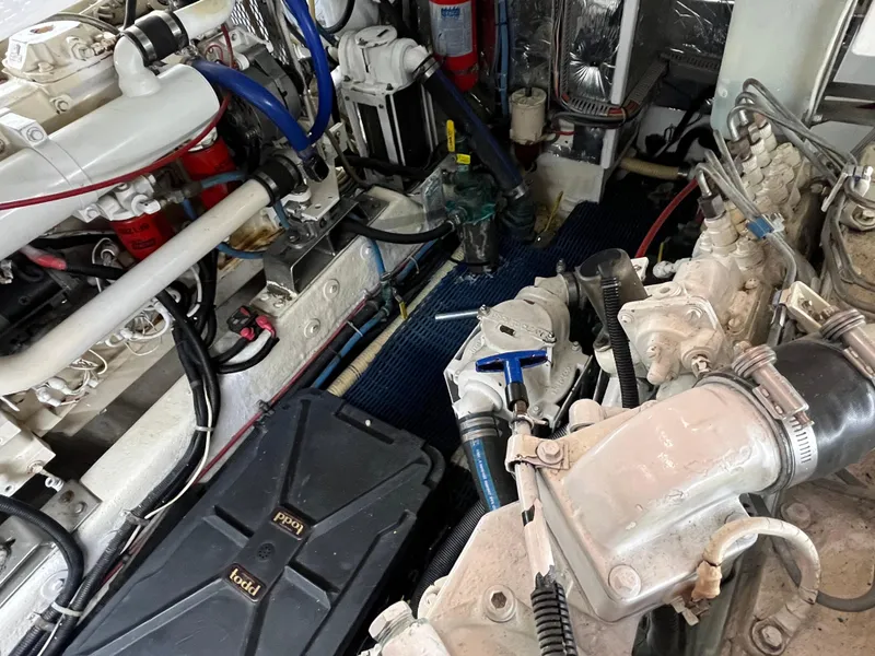 Slide: The Image of Engine room of 1999 Ocean Alexander Sundeck 460, showcasing mechanical components and piping. - 45