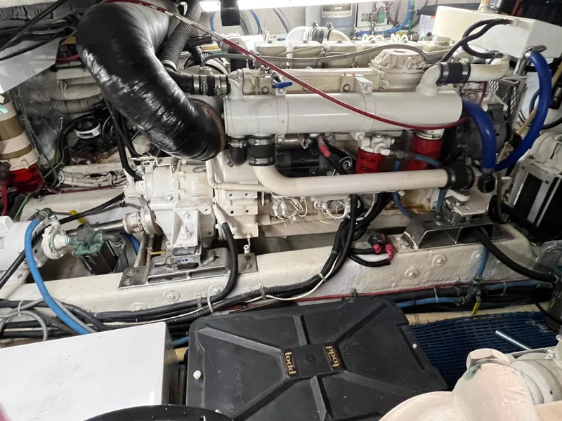 Slide: The Image of Engine room of 1999 Ocean Alexander Sundeck 460 yacht, showcasing mechanical components and wiring. - 47