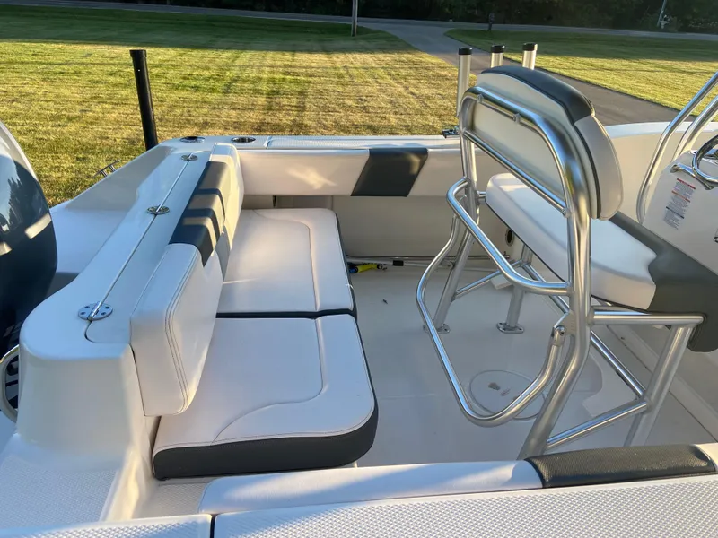 Slide: The Image of 2020 Robalo R202 EX boat interior with cushioned seating and stainless steel railings. - 4