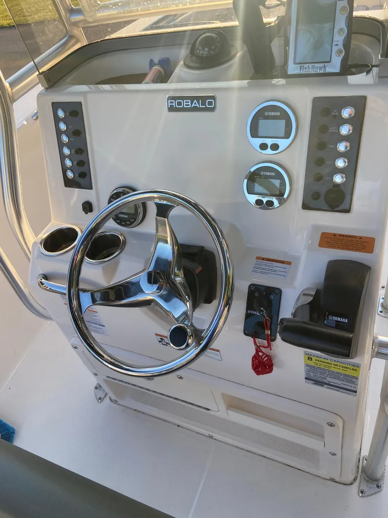 Slide: The Image of 2020 Robalo R202 EX boat dashboard with steering wheel and control panel. - 6