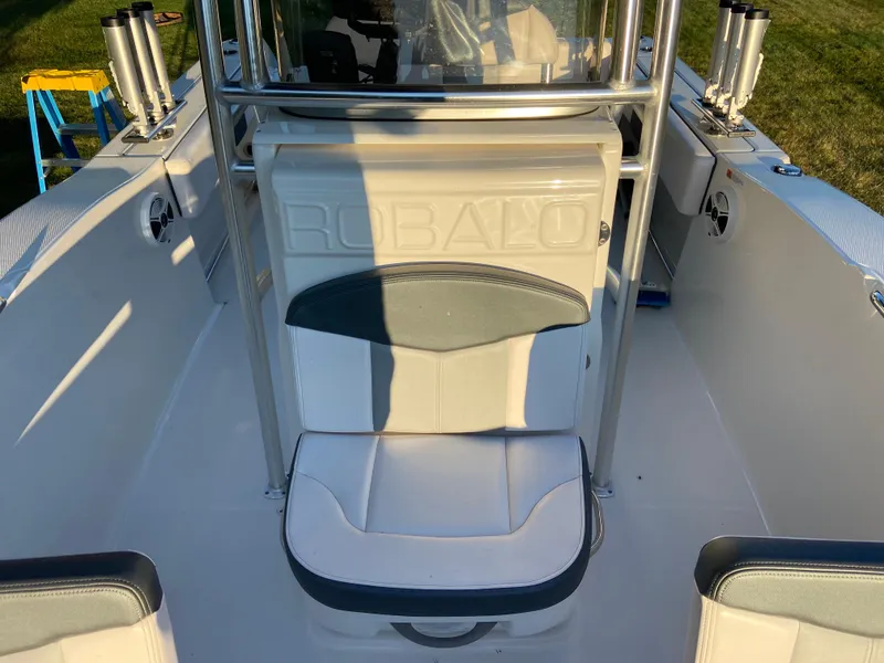Slide: The Image of 2020 Robalo R202 EX boat interior with seating and rod holders. - 7