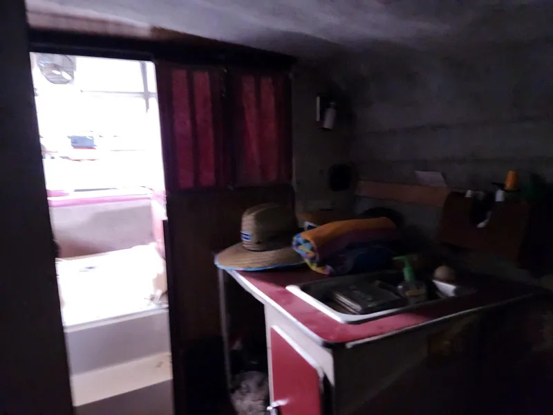 Slide: The Image of Interior of 1987 Larson 23 Cuddy Cabin boat with kitchenette and storage. - 12