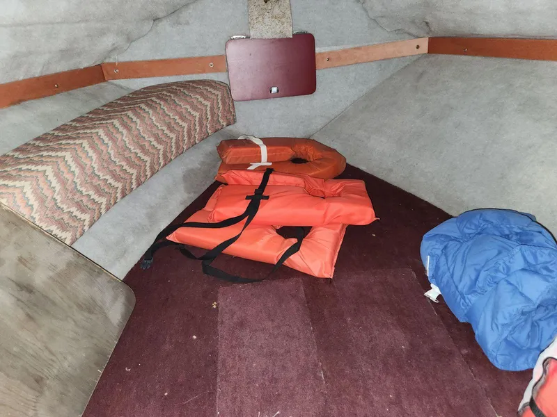 Slide: The Image of 1987 Larson 23 Cuddy Cabin interior with life jackets and cushions. - 5