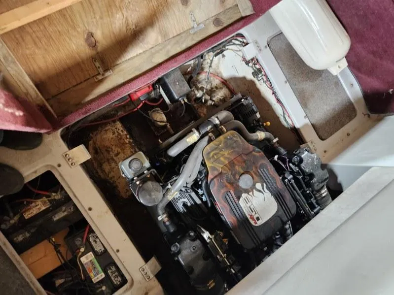 Slide: The Image of Engine compartment of a 1987 Larson 23 Cuddy Cabin boat, showing detailed mechanical components. - 9