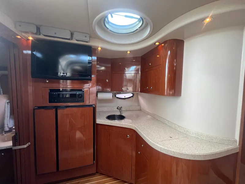 Slide: The Image of Luxurious 2007 Regal Commodore 4060 yacht interior with wood cabinetry and modern amenities. - 17