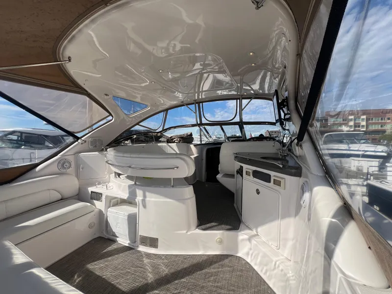 Slide: The Image of Interior of 2007 Regal Commodore 4060 yacht, featuring seating and helm area. - 2