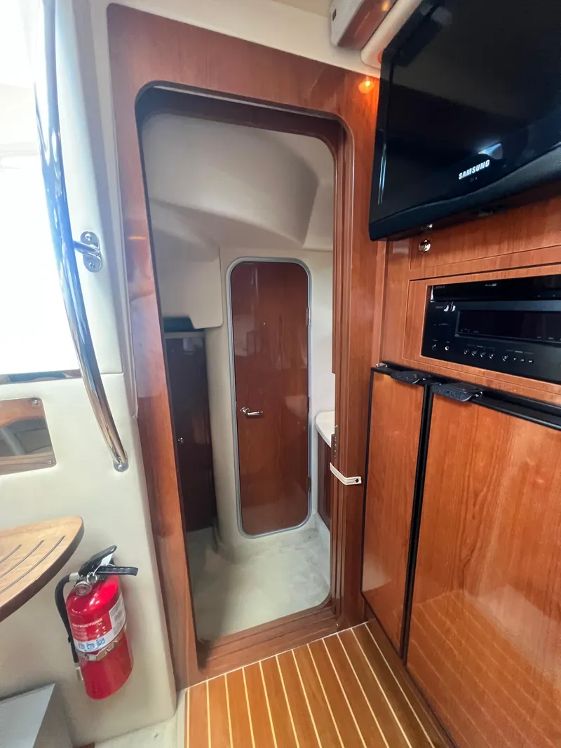 Slide: The Image of Interior of 2007 Regal Commodore 4060 yacht with wood finish and modern amenities. - 21