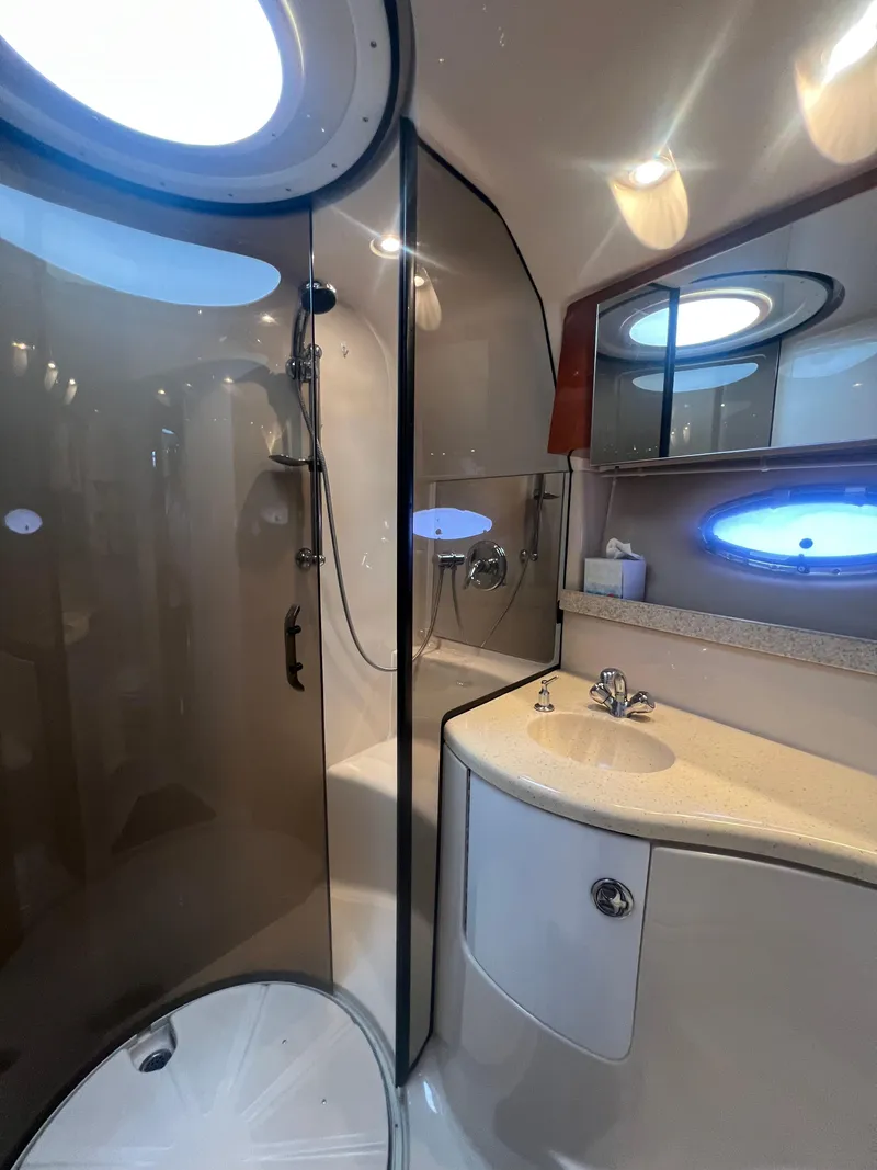 Slide: The Image of Luxurious bathroom in 2007 Regal Commodore 4060 yacht with modern fixtures and porthole window. - 28