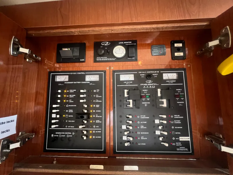 Slide: The Image of Electrical control panel inside 2007 Regal Commodore 4060 boat, featuring various switches and gauges. - 31