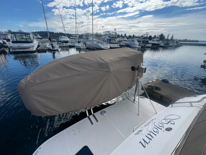 Slide: The Image of 2007 Regal Commodore 4060 yacht docked at marina, covered dinghy on deck, sunny day. - 5