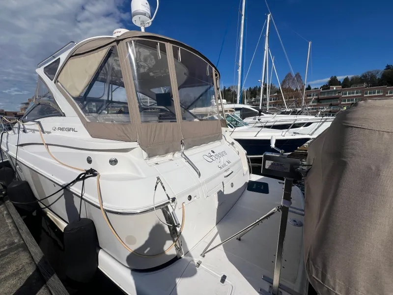 Slide: The Image of 2007 Regal Commodore 4060 yacht docked at marina under clear blue sky. - 6