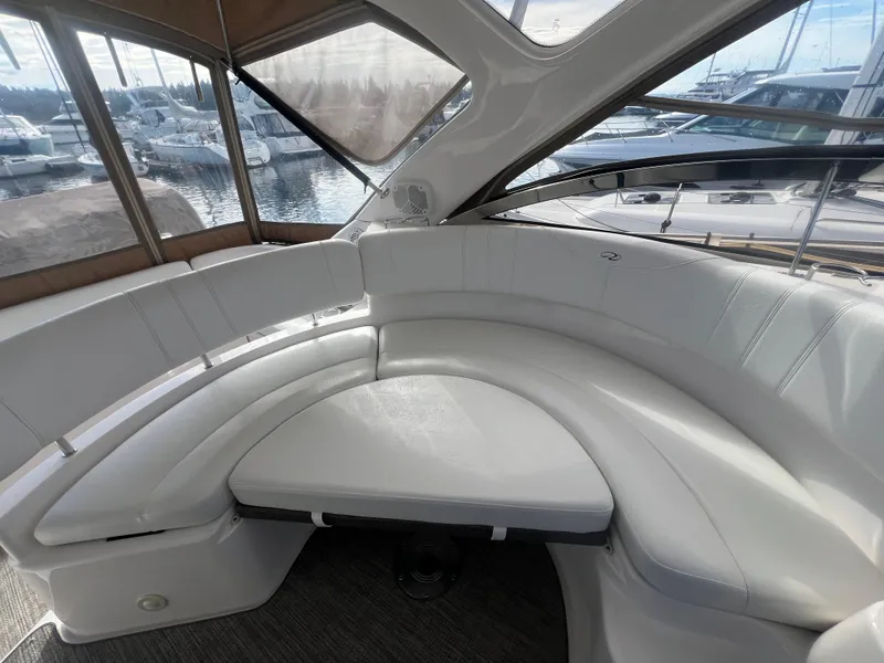 Slide: The Image of 2007 Regal Commodore 4060 yacht interior with white leather seating and panoramic windows. - 7