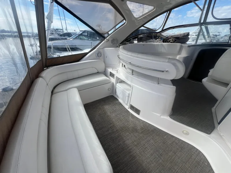 Slide: The Image of 2007 Regal Commodore 4060 yacht interior with white seating and panoramic windows. - 9