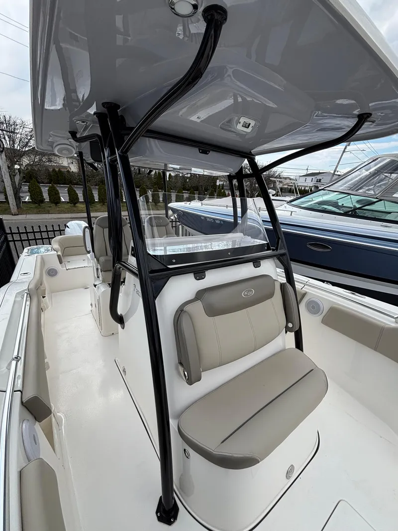 Slide: The Image of 2023 Key West 263FS boat interior with seating and T-top canopy. - 16