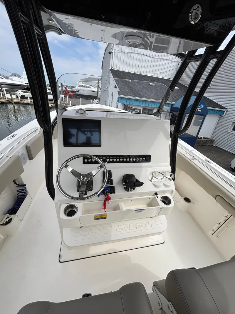 Slide: The Image of 2023 Key West 263FS boat console with steering wheel and navigation screen. - 18