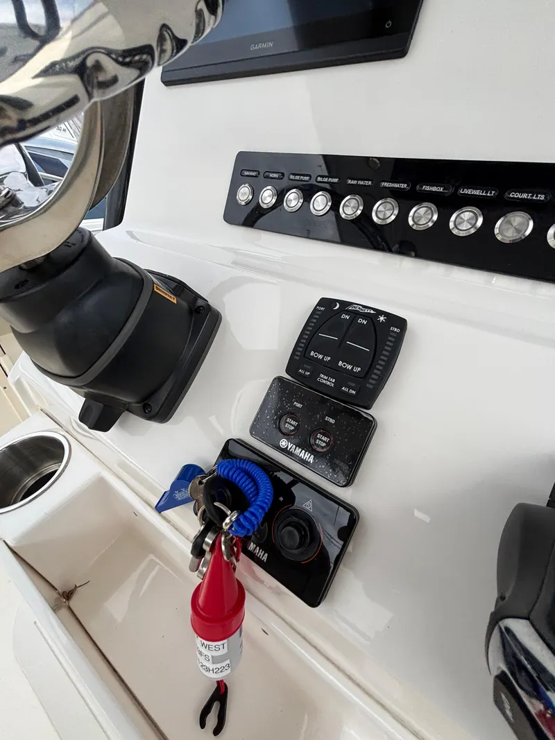 Slide: The Image of 2023 Key West 263FS boat dashboard with controls and ignition keys. - 20