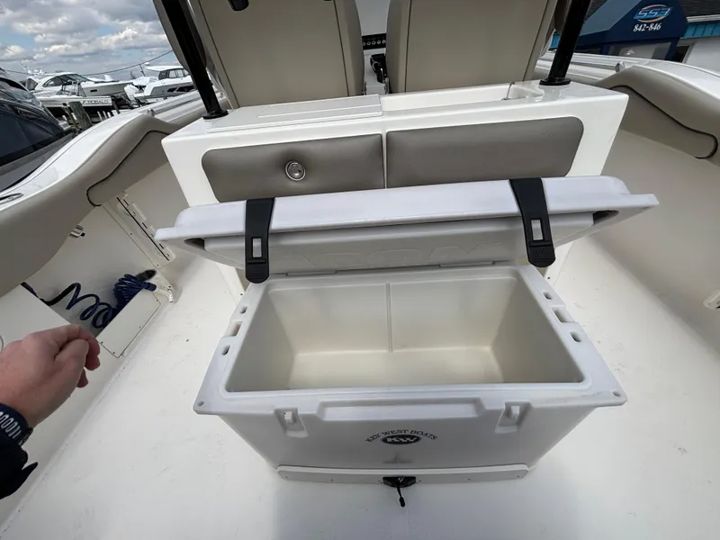 Slide: The Image of Open cooler on 2023 Key West 263FS boat deck, showcasing spacious storage. - 24