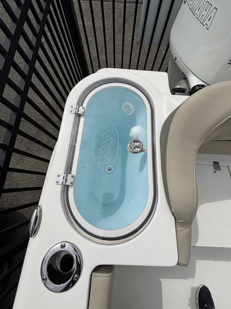 Slide: The Image of 2023 Key West 263FS boat livewell with clear lid and seating area. - 29