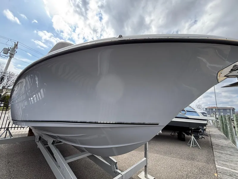 Slide: The Image of 2023 Key West 263FS boat on trailer under cloudy sky. - 32