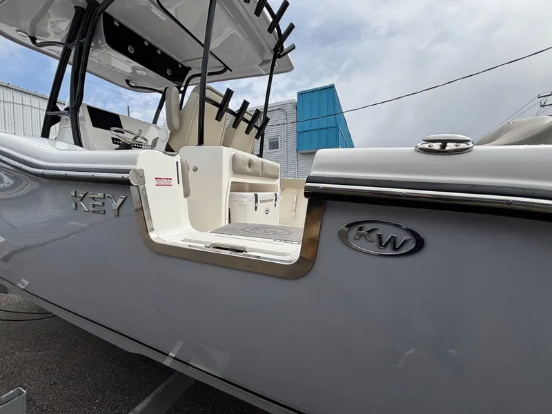 Slide: The Image of 2023 Key West 263FS boat, side view with open door and rod holders. - 6
