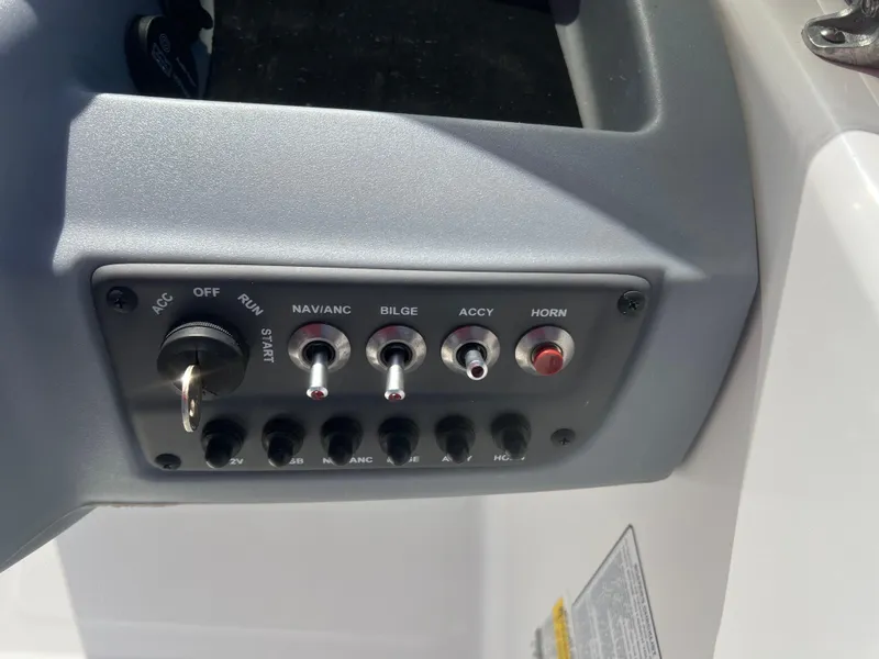 Slide: The Image of Control panel of a 2022 Tahoe T16 boat with switches and ignition key. - 11